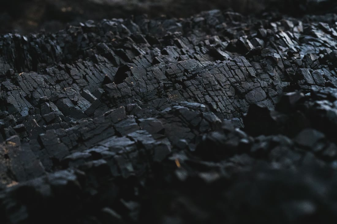 Close view of a dark, layered coal stockpile